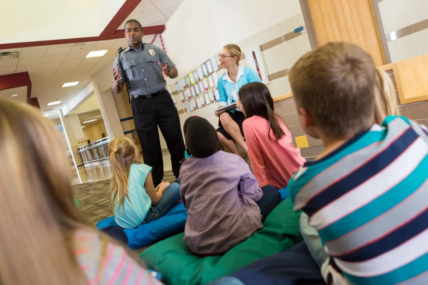 Police officer teaching children Police officer teaching children